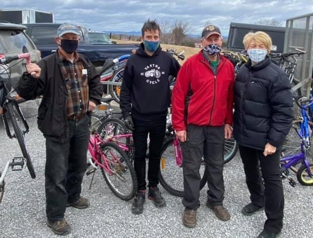 At Yantha Cycles in Pembroke, volunteers Bob Peltzer, Adam Yantha, Ron Moss and Pat Krose display some of the 35 bikes donated by the OPP from their storage.