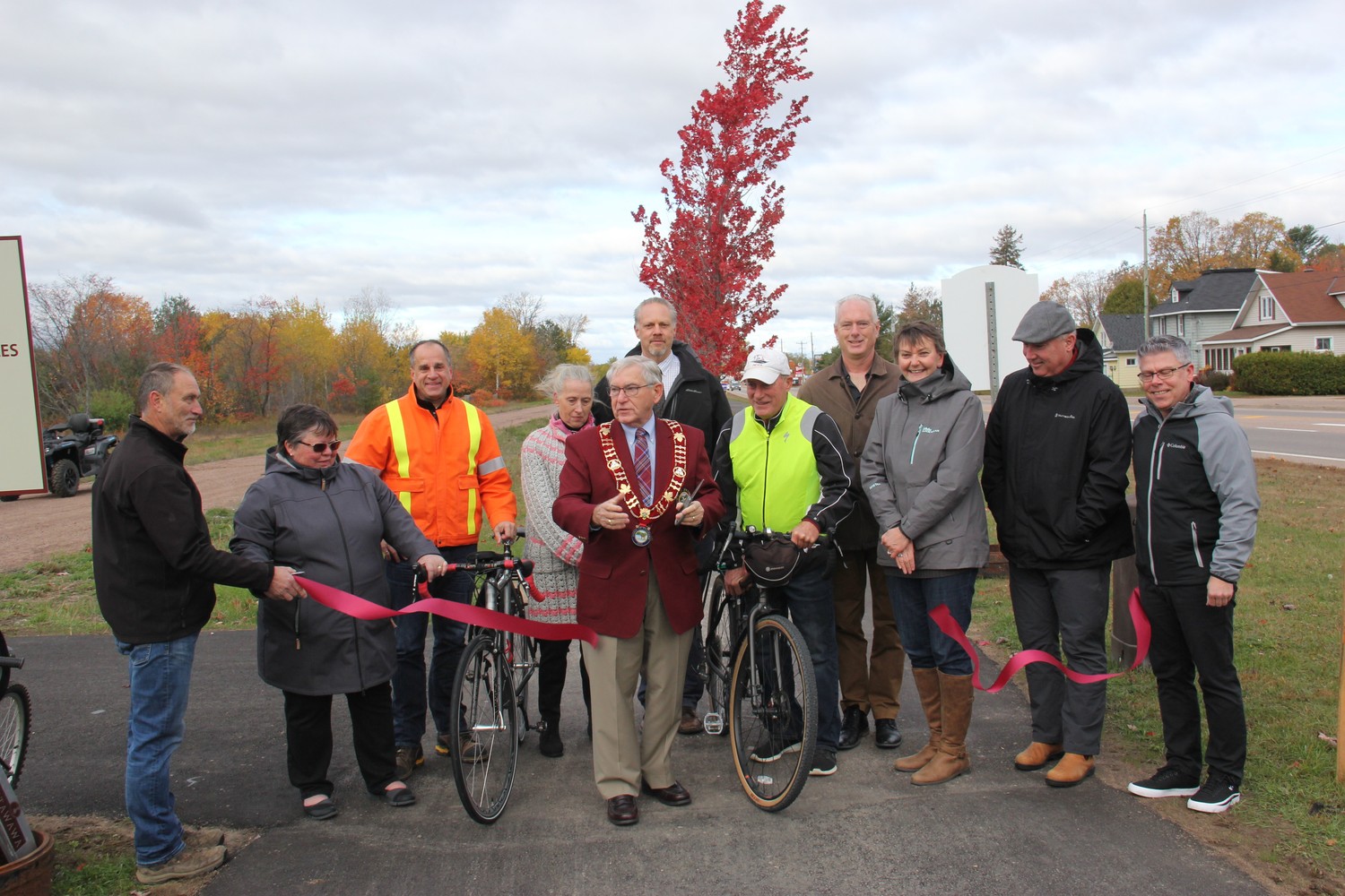Official ribbon cutting in October, 2019 marked the opening of a twinned section of the Algonquin Trail through the urban commercial core of the Town of Petawawa. Members from the various groups involved in the trail attended. In the photo from left, Mark Reinert, Petawawa parks and recreation facilities supervisor, Sheila Clarke, Petawawa Accessibility Advisory Committee member, David Unrau (Petawawa public works director), Laura Lapinskie, constituency assistant to MPP John Yakabuski, Petawawa Mayor Bob Sweet, Jason Davis, manager of forestry and GIS services with Renfrew County, Ron Moss, Ottawa Valley Cycling and Active Transportation Alliance (OVCATA) secretary, Petawawa Councillor James Carmody, Dana Lawson, Garrison Petawawa Personnel Support Programs (PSP) health promotion manager, Kelly Williams, Petawawa community services director, and Petawawa CAO/clerk Dan Scissons. Photo by Anthony Dixon, Pembroke Observer, with permission.