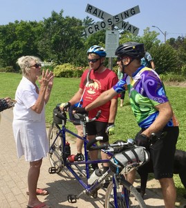 <b>Pam Hooker, co-founder of BeaverTails, talks with blind rider Jeremy Steinberg and his pilot, Paul Jorgenson at the 2024 Tour de BeaverTails.</b>